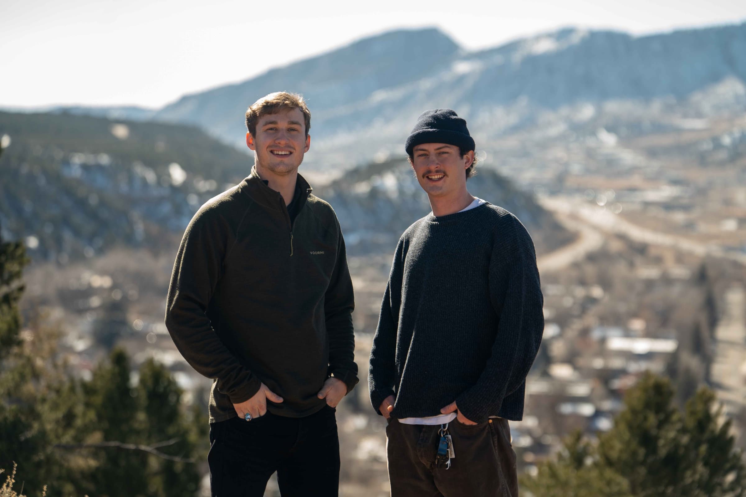 Kahlil and Wes on the rim above Durango in winter, the valley and downtown behind them