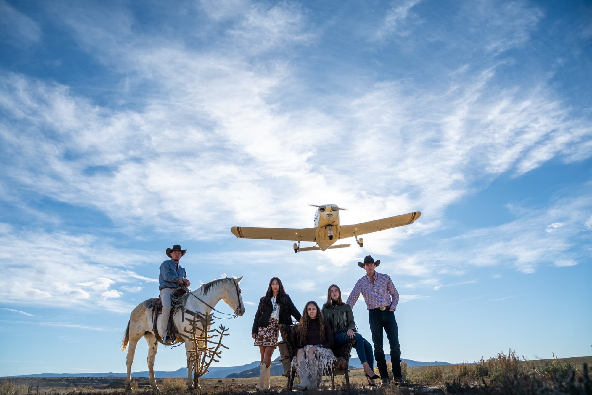 Riders in Pinto Ranch western wear crossing the high desert