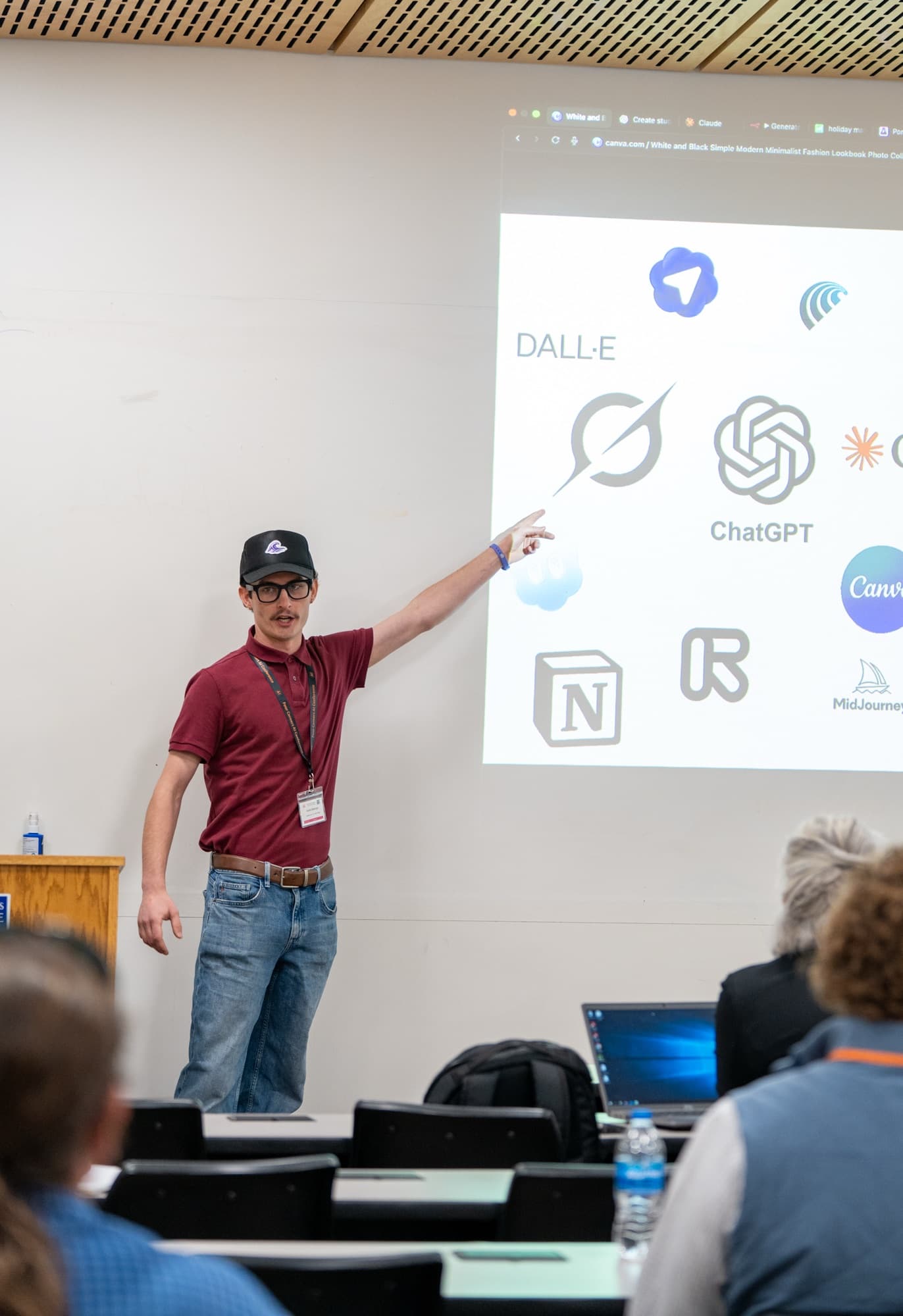 Kahlil presenting at the Four Corners AI Conference, pointing at a slide of AI tools